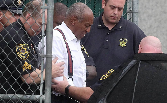 Bill cosby being escorted in police car